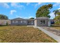 Inviting single-story home with well-maintained lawn and classic architectural details at 11809 129Th Ave, Largo, FL 33778
