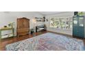 Bright living room showcases hardwood floors, a large rug, and lots of natural light at 11927 Steppingstone Blvd, Tampa, FL 33635