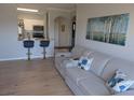 Open concept living area with a view of the kitchen, hardwood floors, and a comfortable sofa at 1216 S Missouri Ave # 223, Clearwater, FL 33756