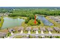 Aerial view of homes backing onto a large pond surrounded by mature trees at 12170 Gothic Rd, Spring Hill, FL 34610