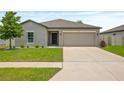 Charming single-story home with an attached two-car garage and manicured lawn at 12170 Gothic Rd, Spring Hill, FL 34610