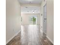 Inviting hallway with wood-look tile flooring leading to a bright living space at 12170 Gothic Rd, Spring Hill, FL 34610
