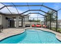 Screened-in pool and patio area, perfect for outdoor entertaining with lounge furniture and ample space at 12653 Palapa Loop, Spring Hill, FL 34610