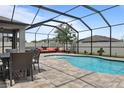 Inviting screened-in pool with outdoor dining and lounge area, great for relaxing and entertaining at 12653 Palapa Loop, Spring Hill, FL 34610