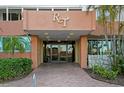Welcoming building entrance with glass doors, brick pathway and professional landscaping at 17920 Gulf Blvd # 1901, Redington Shores, FL 33708