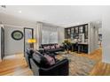 Elegant living room with hardwood floors, a built-in bar, and comfortable seating at 213 N Hesperides St, Tampa, FL 33609