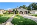 Beautiful single-Gathering home featuring a well-manicured lawn and an attached two-car garage at 2134 Serpentine S Cir, St Petersburg, FL 33712
