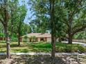 Ranch-style house with mature trees and green lawn at 2217 High Point Dr, Brandon, FL 33511