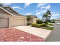 Attractive villa boasting a well-maintained exterior and colorful landscaping at 2403 Nantucket Field Way # 27, Sun City Center, FL 33573