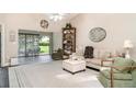 Bright living room featuring hardwood floors, comfortable seating, and natural light at 2403 Nantucket Field Way # 27, Sun City Center, FL 33573