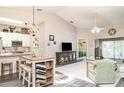 Open-concept living area with vaulted ceilings, modern furnishings, and seamless flow to the kitchen and outdoor spaces at 2403 Nantucket Field Way # 27, Sun City Center, FL 33573
