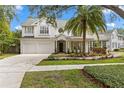 Beautiful two-story home with a well-manicured lawn, a two-car garage, and a welcoming front porch at 2403 W Sunset Dr, Tampa, FL 33629