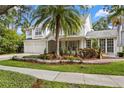 Inviting two-story home with a lush front yard, a two-car garage, and a charming front entrance at 2403 W Sunset Dr, Tampa, FL 33629