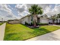 Lovely home with a green lawn, privacy fence, and well-maintained landscaping at 2456 Arbor Wind Dr, Lutz, FL 33558