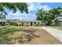 Charming one-story home with a well-maintained lawn and covered entryway at 3919 W Paxton Ave, Tampa, FL 33611