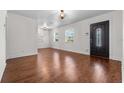 Bright living room with hardwood floors and decorative front door at 3919 W Paxton Ave, Tampa, FL 33611