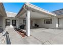 The carport area with its white pillars and ample parking space at 4039 La Pasida Ln, New Port Richey, FL 34655