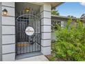 A gated front entrance features gray columns and a 'welcome' sign at 6310 Gainsboro Ave, Spring Hill, FL 34609