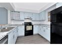 Bright kitchen featuring blue cabinets, updated countertops and stainless steel sink at 6817 Stones Throw N Cir # 17203, St Petersburg, FL 33710