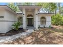 A welcoming front entry with a dark door and manicured landscaping at 7644 Conrad St, Wesley Chapel, FL 33544