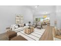 Open living room featuring dining area and modern decor at 7644 Conrad St, Wesley Chapel, FL 33544