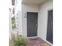 Close up of a unit entrance with security screen door and welcome mats at 9217 Tudor Dr # A106, Tampa, FL 33615