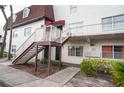 Exterior of condo building with stairs leading to upper units and neatly maintained grounds at 9217 Tudor Dr # A106, Tampa, FL 33615