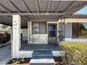 Close up view of a charming covered front porch featuring stone accents, metal railings, and the house number at 922 Alcazar S Way, St Petersburg, FL 33705