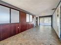 Bright sun room with tile floor and walls of windows overlooking the backyard with sliding glass doors at 922 Alcazar S Way, St Petersburg, FL 33705
