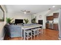 Inviting living area with hardwood floors, neutral tones, bar seating and open to stainless kitchen at 109 S Packwood Ave # B, Tampa, FL 33606