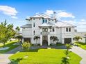 Beautiful white home with lush green lawn and two-car garage, perfect for Gathering living at 110 Carlyle Dr, Palm Harbor, FL 34683