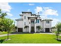 Stunning multi-story modern home featuring manicured lawn and two-car garage in a desirable neighborhood at 110 Carlyle Dr, Palm Harbor, FL 34683