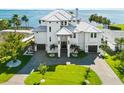 Luxury waterfront home featuring lush landscaping and a pristine exterior, with stunning curb appeal at 110 Carlyle Dr, Palm Harbor, FL 34683
