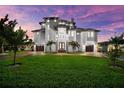 Stunning multi-story home with lush lawn, two garages, and inviting entryway at 110 Carlyle Dr, Palm Harbor, FL 34683