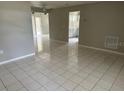 Open-concept living space featuring tile floors and access to kitchen at 116 Cranbrooke Dr, Seffner, FL 33584