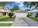 Well-maintained single-Gathering home with manicured lawn and a concrete driveway at 11728 Crest Creek Dr, Riverview, FL 33569