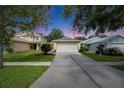 Well-maintained single-Gathering home with manicured lawn and a concrete driveway at 11728 Crest Creek Dr, Riverview, FL 33569