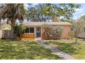 Charming single-story home featuring a stone pathway, manicured lawn, and inviting front porch at 131 44Th N Ave, St Petersburg, FL 33703