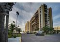 A condo building with palm trees and parking at 1480 Gulf Blvd # 905, Clearwater Beach, FL 33767