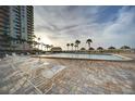 Inviting pool area with chaise lounges for relaxing and enjoying the sun at 1480 Gulf Blvd # 905, Clearwater Beach, FL 33767