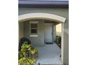 Cozy front porch featuring a seating area and potted plants at 16725 Delia St, Wimauma, FL 33598