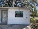 Up-close side exterior view of the home with visible address number and a closed front door at 1716 Lancelot Loop, Tampa, FL 33619