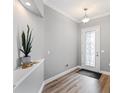Bright foyer featuring stylish flooring, a decorative plant, and an ornate front door at 1767 Tonka Ter, Wesley Chapel, FL 33543