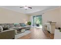 Open-concept living room with sliding doors to lanai and a charming bar area at 18148 Nassau Point Dr, Tampa, FL 33647