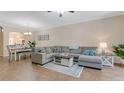 Inviting living room featuring a large sectional couch and wood-look flooring at 18148 Nassau Point Dr, Tampa, FL 33647