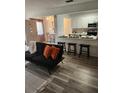 Bright living area featuring an open floor plan to the dining and kitchen areas at 1833 Bough Ave # 2, Clearwater, FL 33760