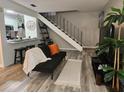 Cozy living room featuring stairs, modern furniture, and stylish decor at 1833 Bough Ave # 2, Clearwater, FL 33760