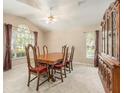Traditional dining room featuring a wood table, six chairs, and large window for natural light at 18967 Wood Sage Dr, Tampa, FL 33647