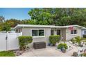Exterior view of a well-maintained home with tidy landscaping and walkway at 1921 Ridgewood Dr, Clearwater, FL 33763