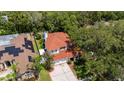 Aerial view of a beautiful two-story home nestled among mature trees, showcasing its well-maintained surroundings at 2015 Long Branch Ln, Clearwater, FL 33760
